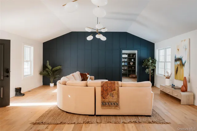 a living room with a couch and a chandelier