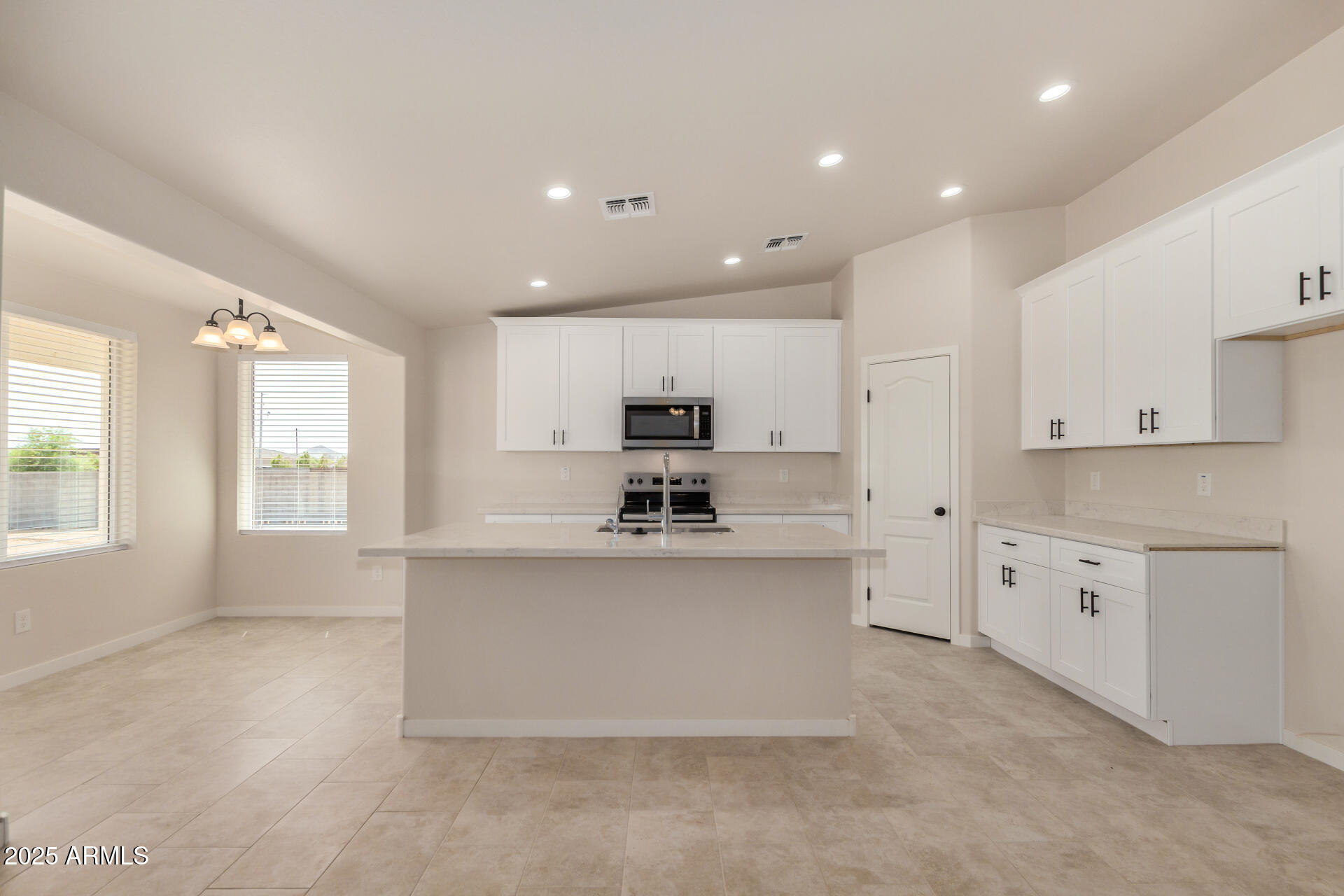 20375 West Carver Road Buckeye, AZ 85326 - Photo 14 of 44 a large kitchen with granite countertop a large counter top stainless steel appliances and cabinets