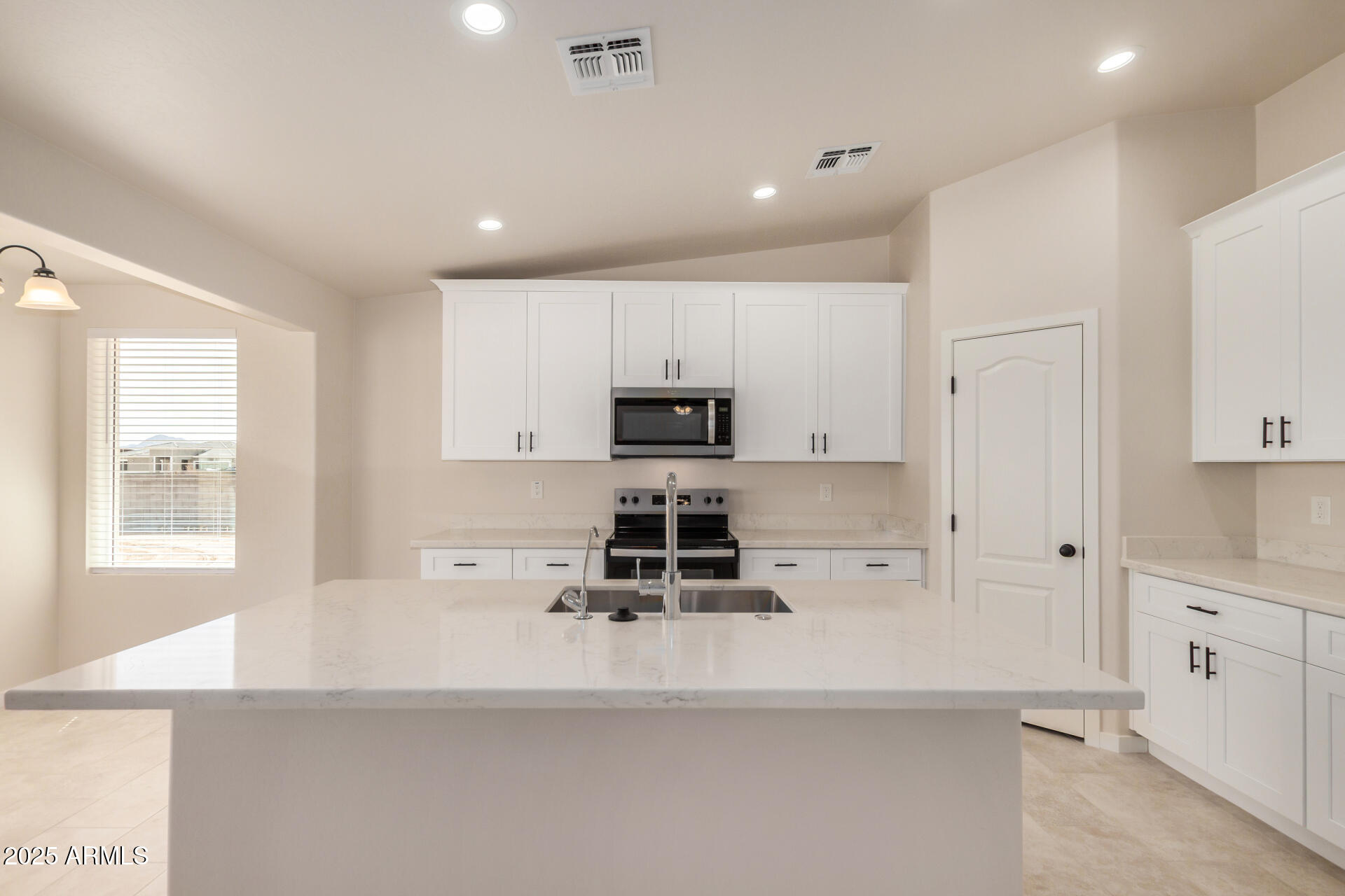 20375 West Carver Road Buckeye, AZ 85326 - Photo 15 of 44 a kitchen with stainless steel appliances a stove refrigerator sink and cabinets