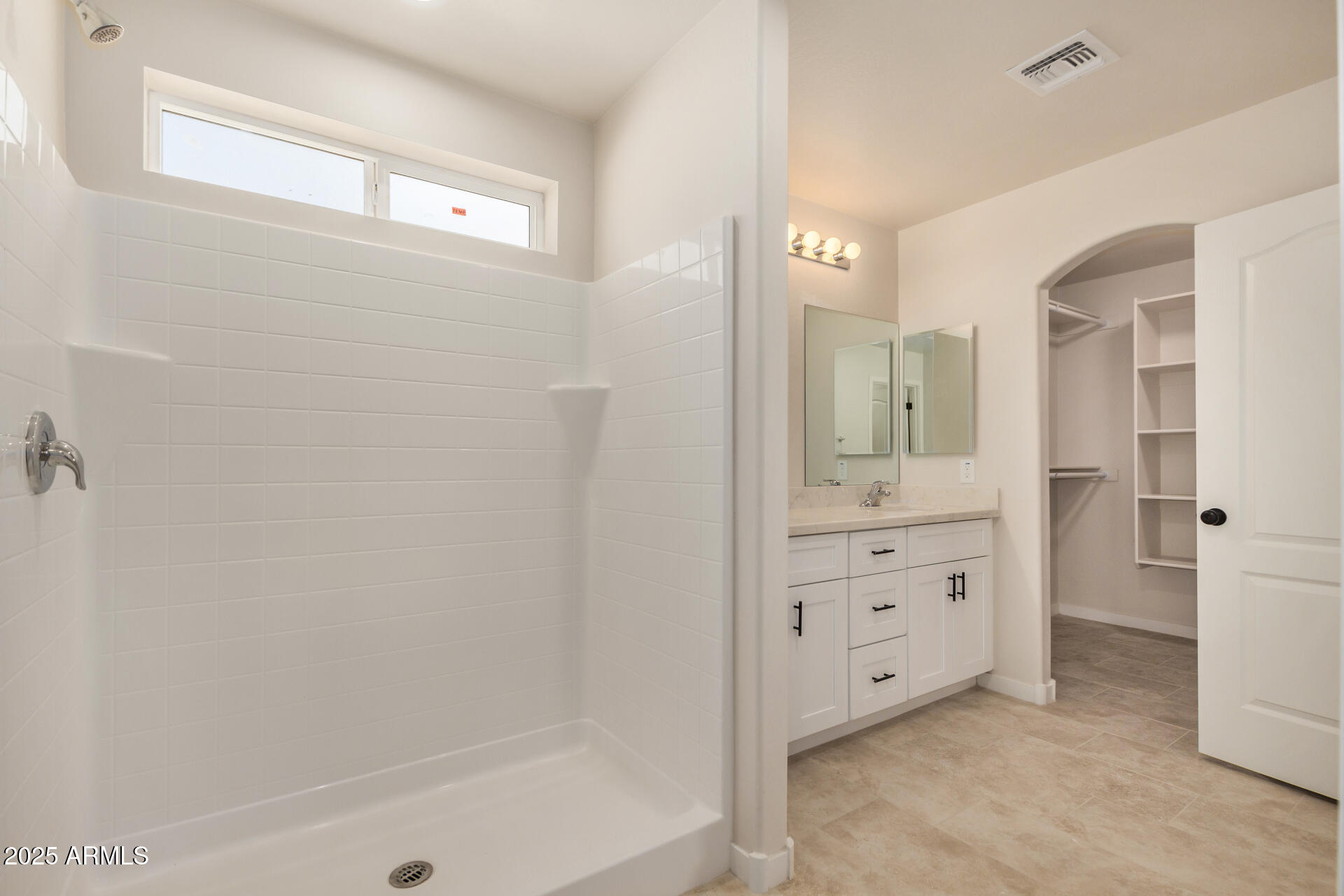 20375 West Carver Road Buckeye, AZ 85326 - Photo 24 of 44 a bathroom with a granite countertop sink a mirror and a bathtub