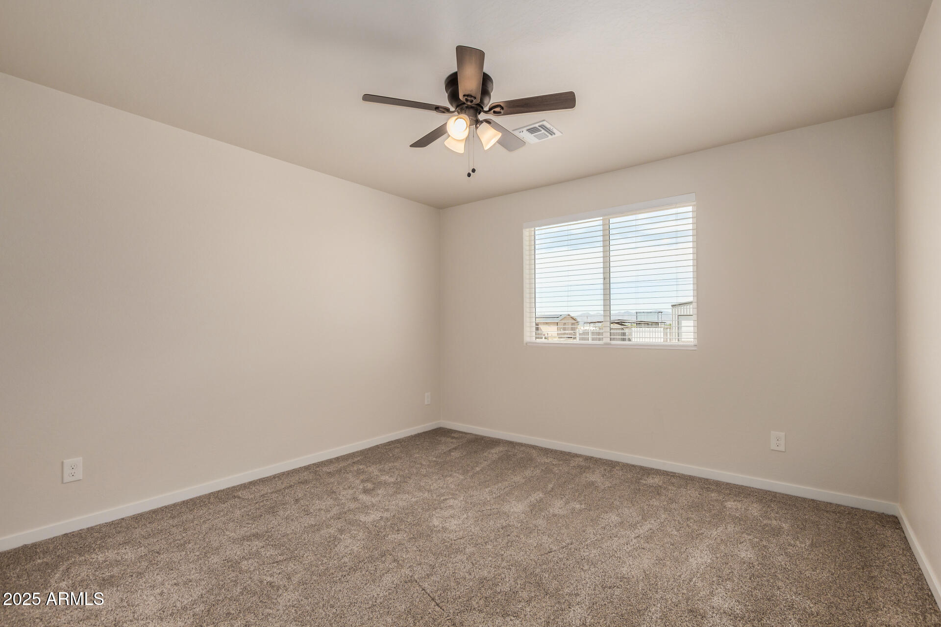 20375 West Carver Road Buckeye, AZ 85326 - Photo 29 of 44 an empty room with a window and a ceiling fan