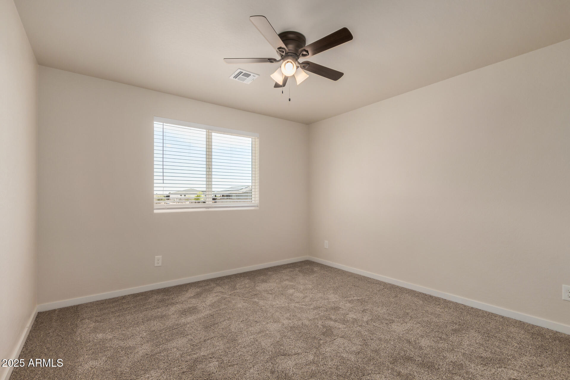 20375 West Carver Road Buckeye, AZ 85326 - Photo 31 of 44 an empty room with a window and a ceiling fan