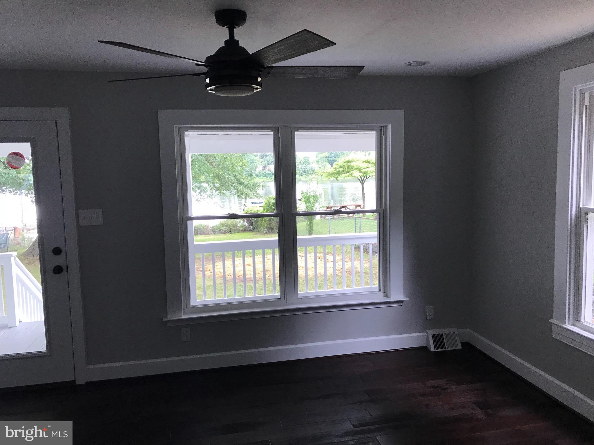 7530 East Battle Grove Road Dundalk, MD 21222 - Photo 14 of 27 a view of an empty room with wooden floor and a window