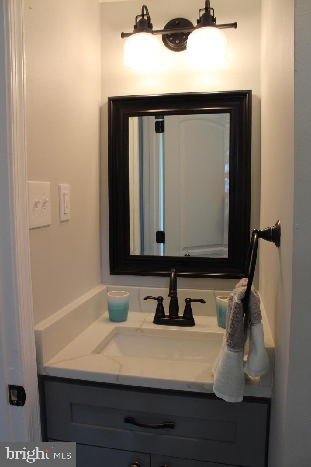 7530 East Battle Grove Road Dundalk, MD 21222 - Photo 16 of 27 a bathroom with a sink and a mirror