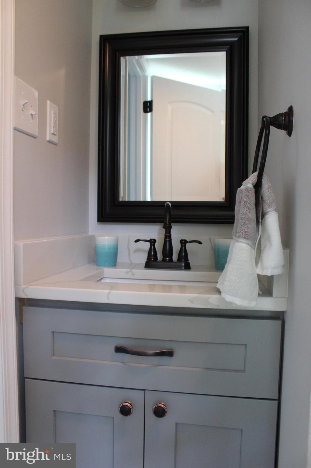 7530 East Battle Grove Road Dundalk, MD 21222 - Photo 17 of 27 a bathroom with a sink vanity and a mirror