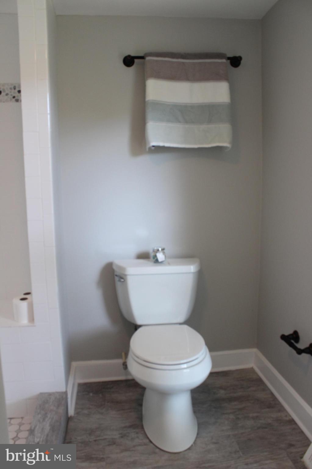 7530 East Battle Grove Road Dundalk, MD 21222 - Photo 18 of 27 a white toilet sitting next to a bathroom sink