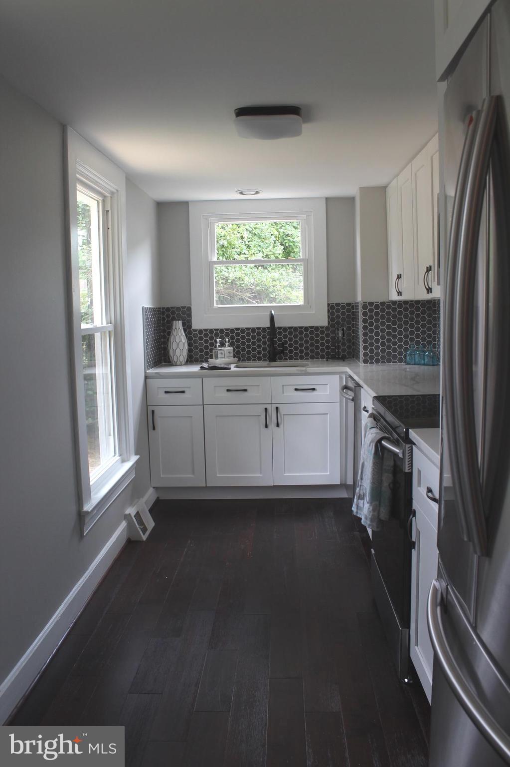 7530 East Battle Grove Road Dundalk, MD 21222 - Photo 3 of 27 a kitchen with a sink a refrigerator and window