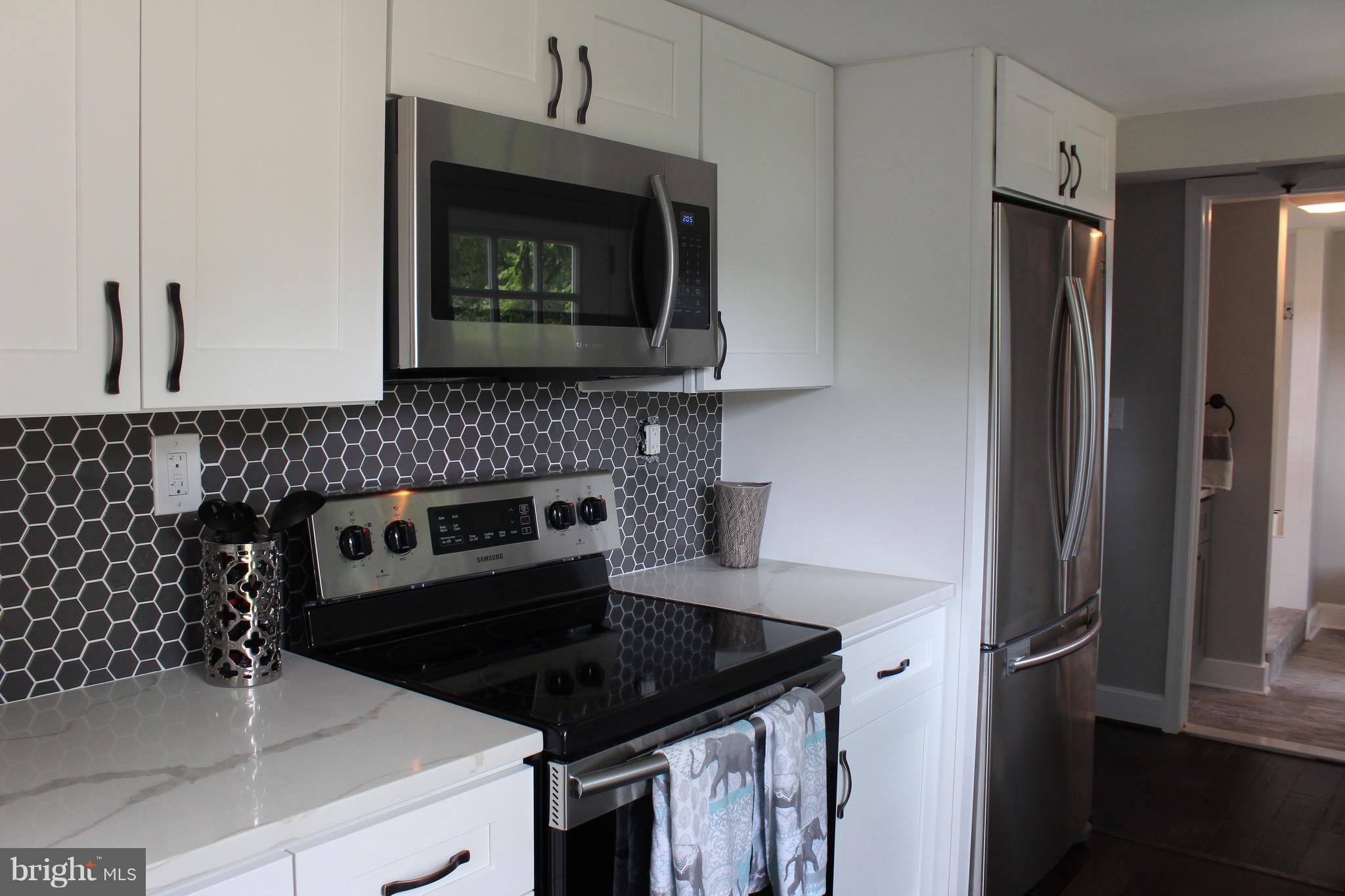 7530 East Battle Grove Road Dundalk, MD 21222 - Photo 5 of 27 a kitchen with a sink stove and refrigerator