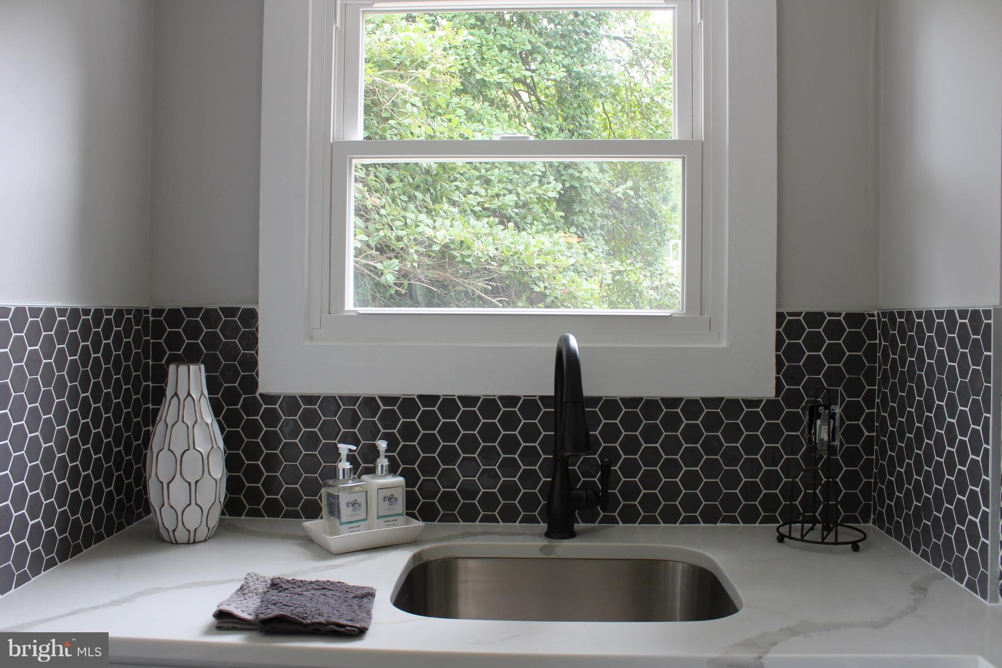 7530 East Battle Grove Road Dundalk, MD 21222 - Photo 6 of 27 a bathroom with a sink and a window