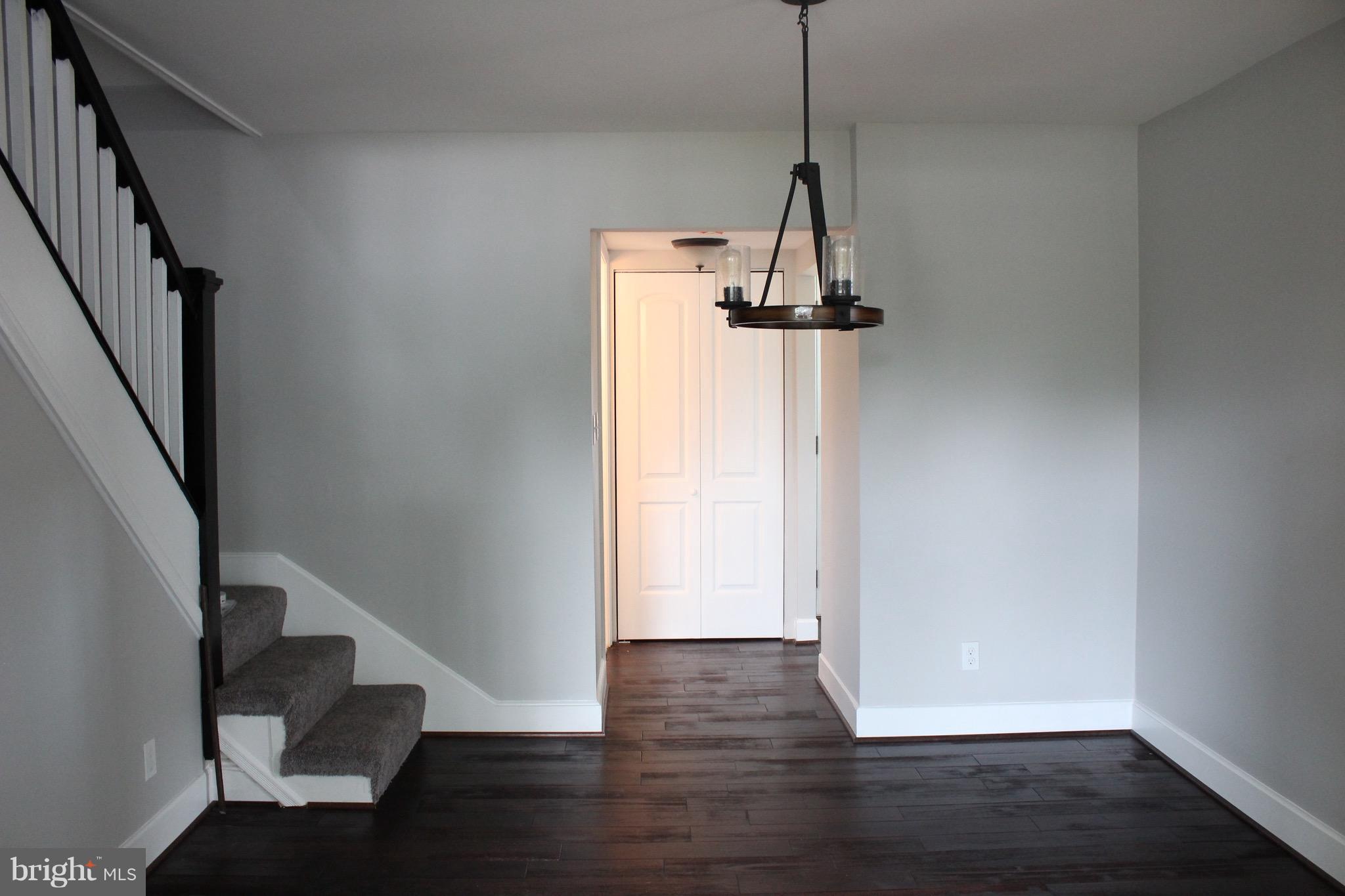 7530 East Battle Grove Road Dundalk, MD 21222 - Photo 7 of 27 a view of a hallway with wooden floor and stairs