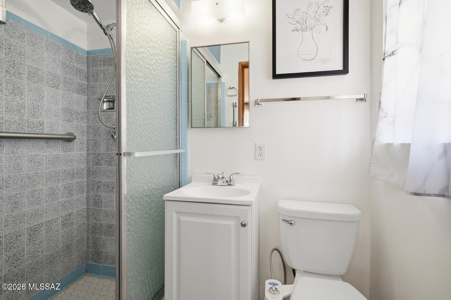 336 East 24th Street Tucson, AZ 85713 - Photo 21 of 27 a bathroom with a sink mirror and toilet