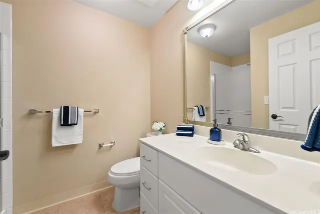 a bathroom with a toilet a sink and mirror