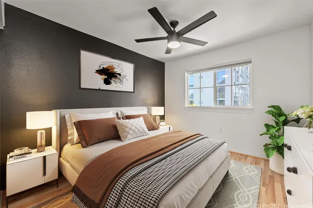 a bedroom with bed and paintings on the wall
