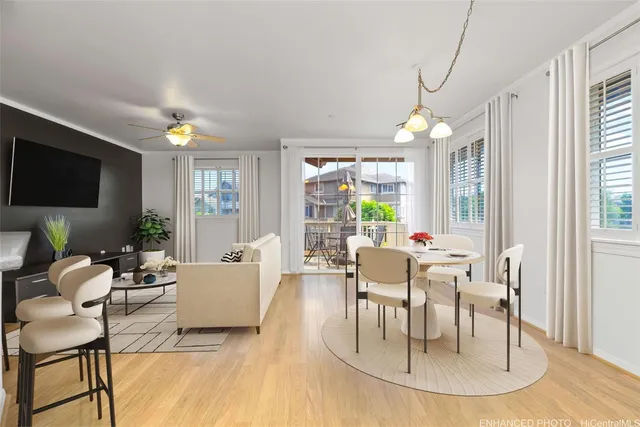 a living room with furniture a flat screen tv and a large window