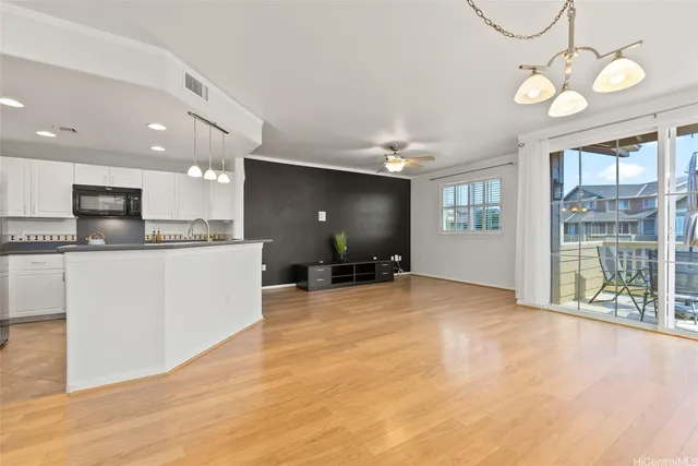 a view of a kitchen with a sink and cabinets