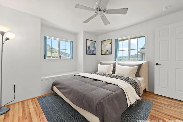 a bedroom with bed and wooden floor