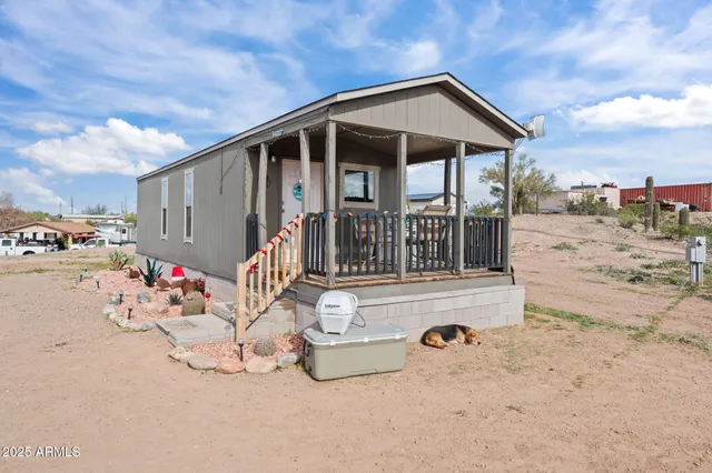 a living room with furniture a refrigerator and a window