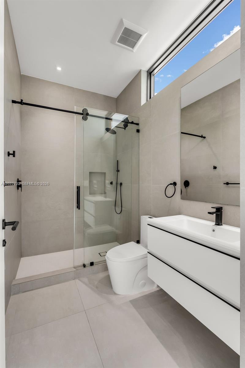 7825 Southwest 128th Street Pinecrest, FL 33156 - Photo 48 of 88 a bathroom with a sink a toilet and shower