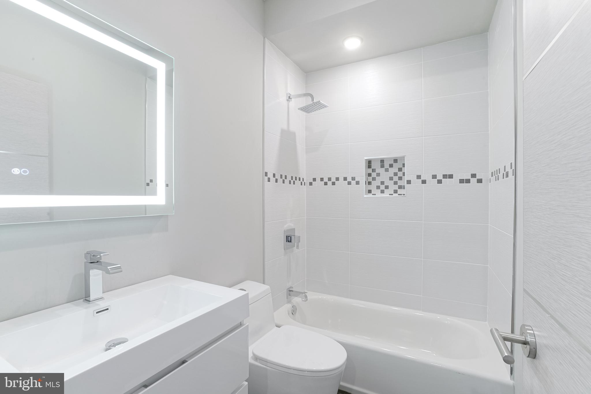 1630 Cambridge Street, Unit B Philadelphia, PA 19130 - Photo 13 of 24 a bathroom with a sink toilet vanity and shower