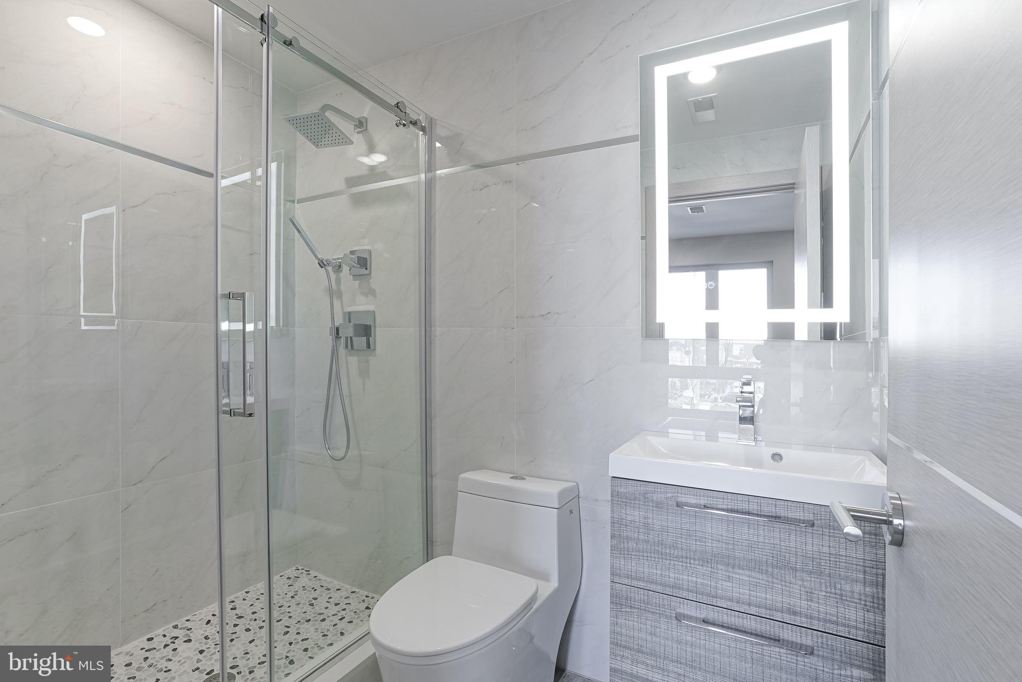 1630 Cambridge Street, Unit B Philadelphia, PA 19130 - Photo 14 of 24 a bathroom with a shower a sink a toilet and shower