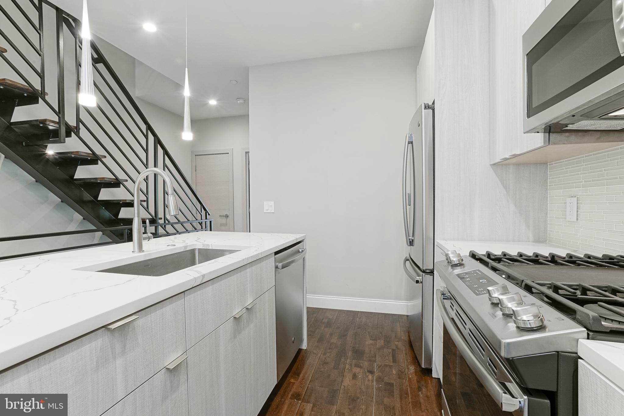 1630 Cambridge Street, Unit B Philadelphia, PA 19130 - Photo 15 of 24 a kitchen that has a sink and a stove