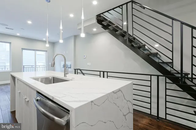 a kitchen with a sink a stove and cabinets