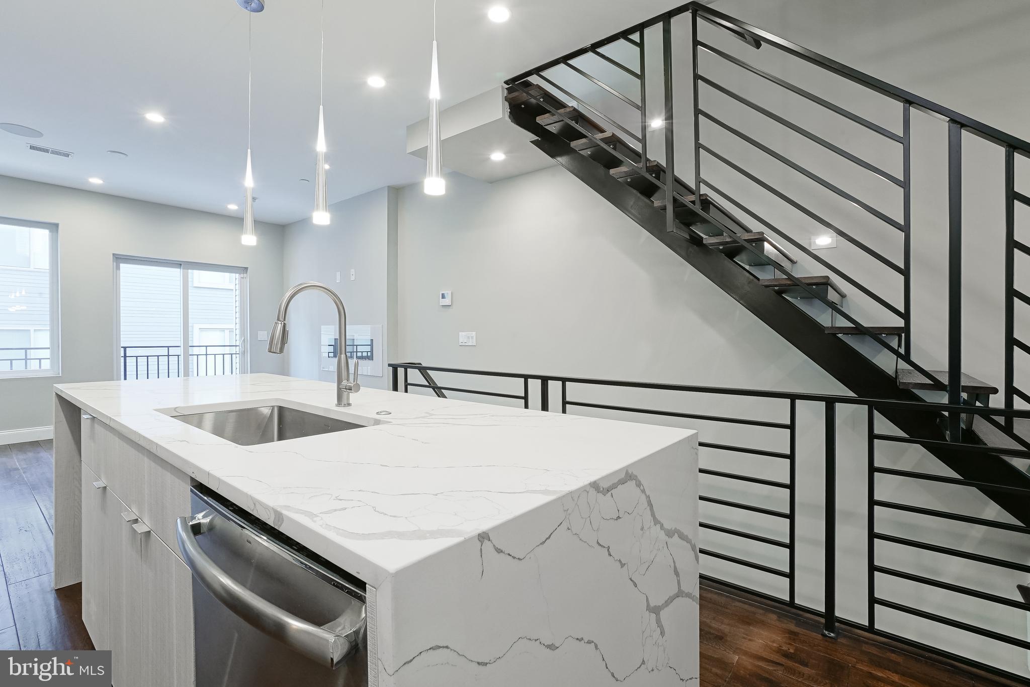 1630 Cambridge Street, Unit B Philadelphia, PA 19130 - Photo 16 of 24 a kitchen with a sink a stove and cabinets