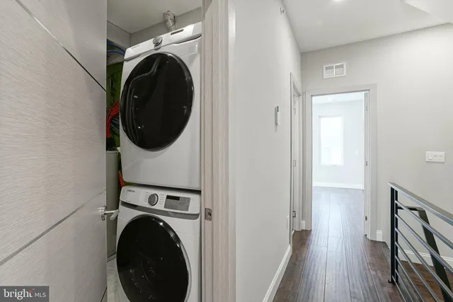 a view of a hallway with washer and dryer