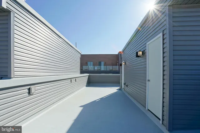 a view of a balcony with refrigerator