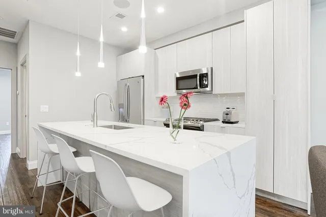 a kitchen with a sink a microwave and cabinets