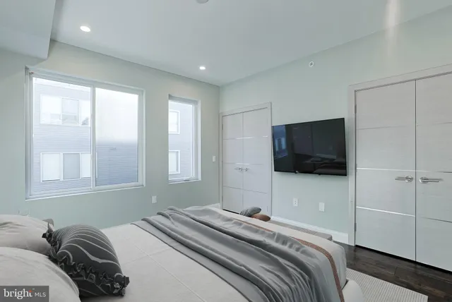 a bedroom with a bed and a flat screen tv