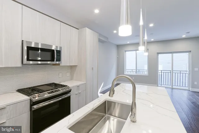 a kitchen with a microwave a stove and a sink
