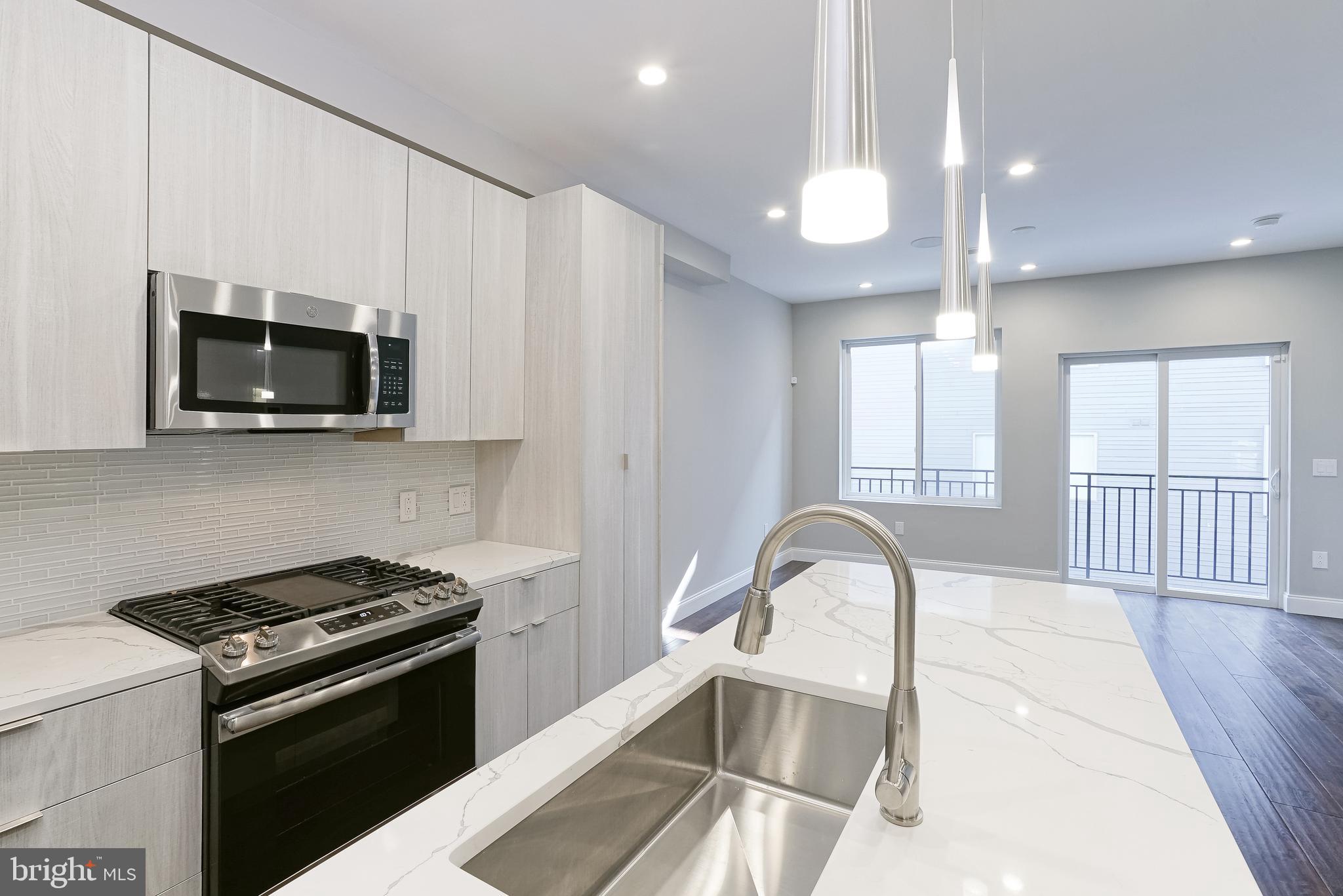 1630 Cambridge Street, Unit B Philadelphia, PA 19130 - Photo 10 of 24 a kitchen with a microwave a stove and a sink