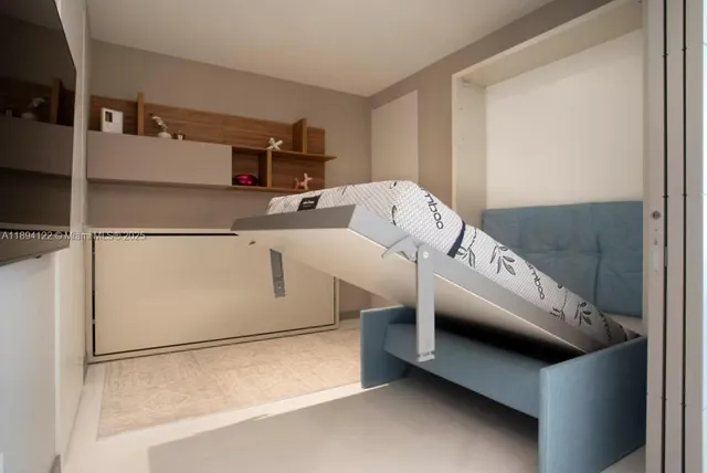 a bedroom with a bed and a cabinets