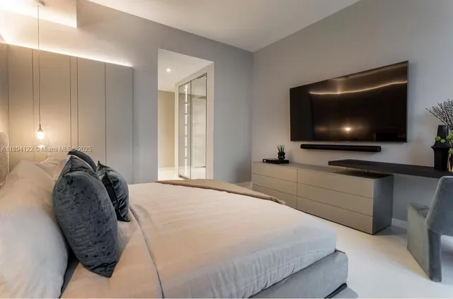 a bedroom with a bed and a flat screen tv