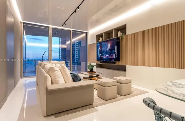 a living room with furniture potted plant and kitchen