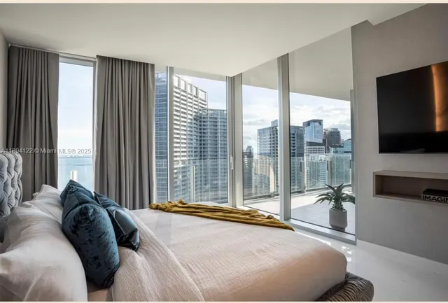 a bedroom with a bed and table