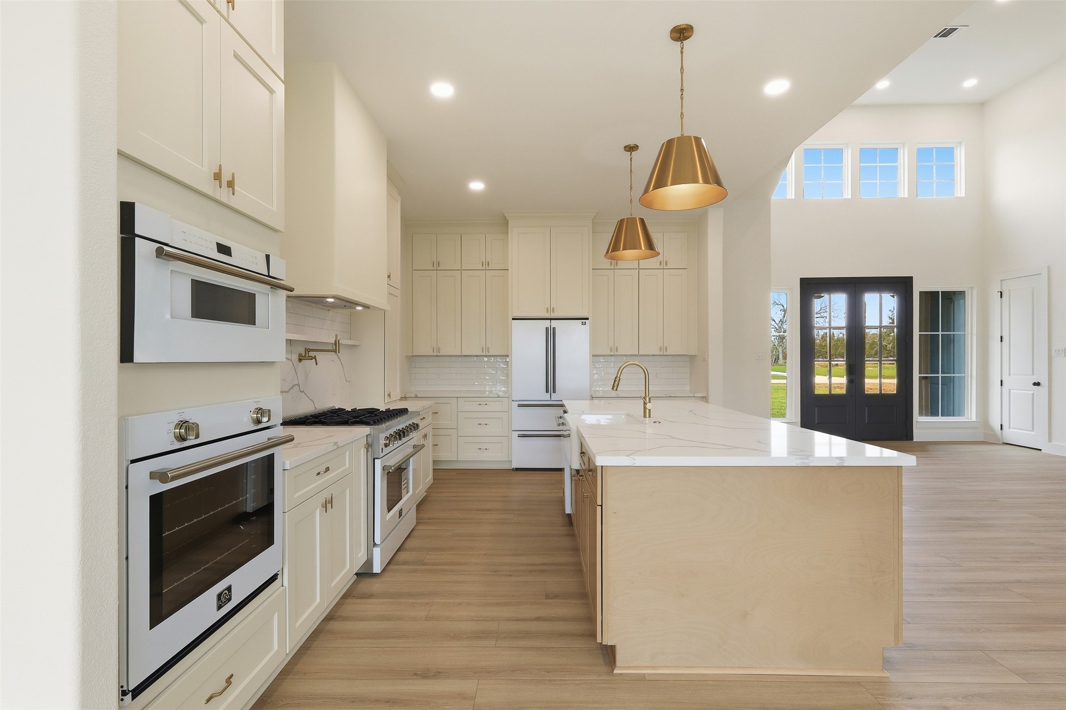467 Springfield Drive Angleton, TX 77515 - Photo 12 of 42 a large kitchen with stainless steel appliances granite countertop a sink a stove and a refrigerator