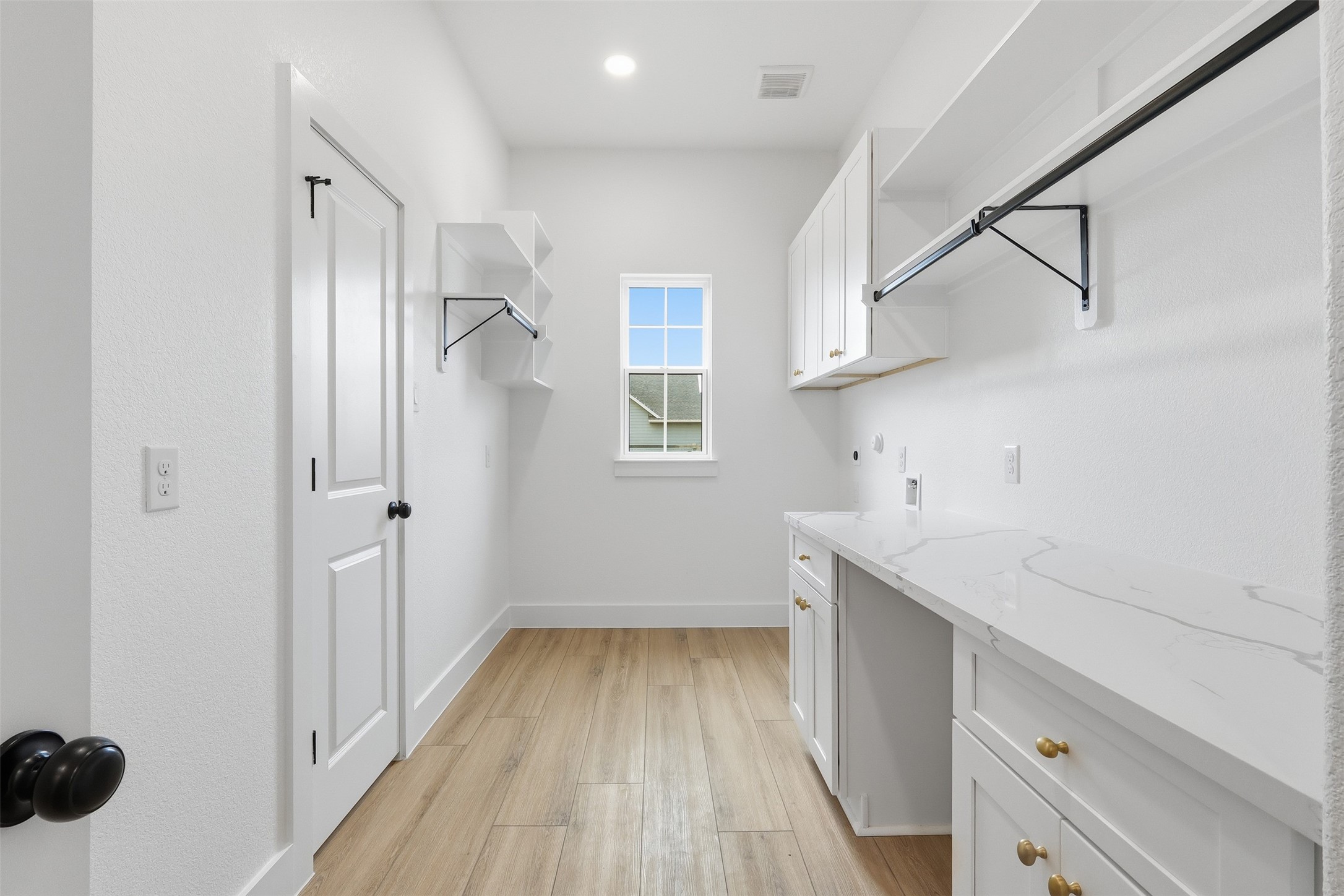 467 Springfield Drive Angleton, TX 77515 - Photo 23 of 42 a room with a white wooden cabinets and entryway