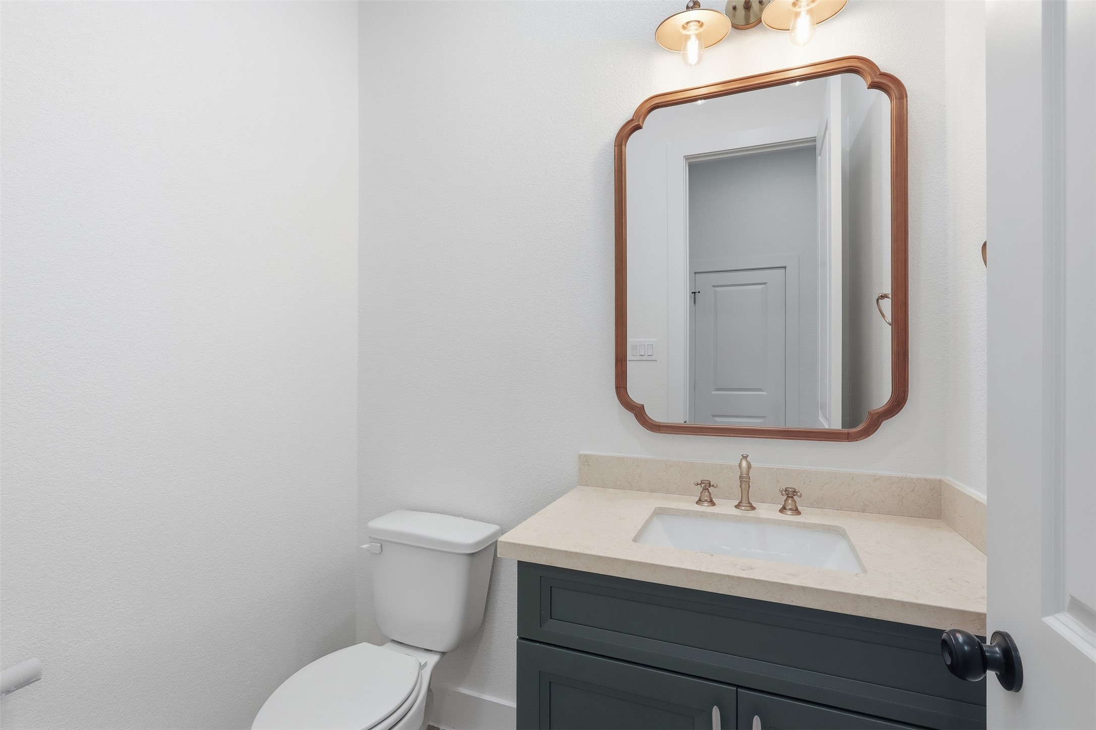 467 Springfield Drive Angleton, TX 77515 - Photo 24 of 42 a bathroom with a toilet sink vanity and mirror