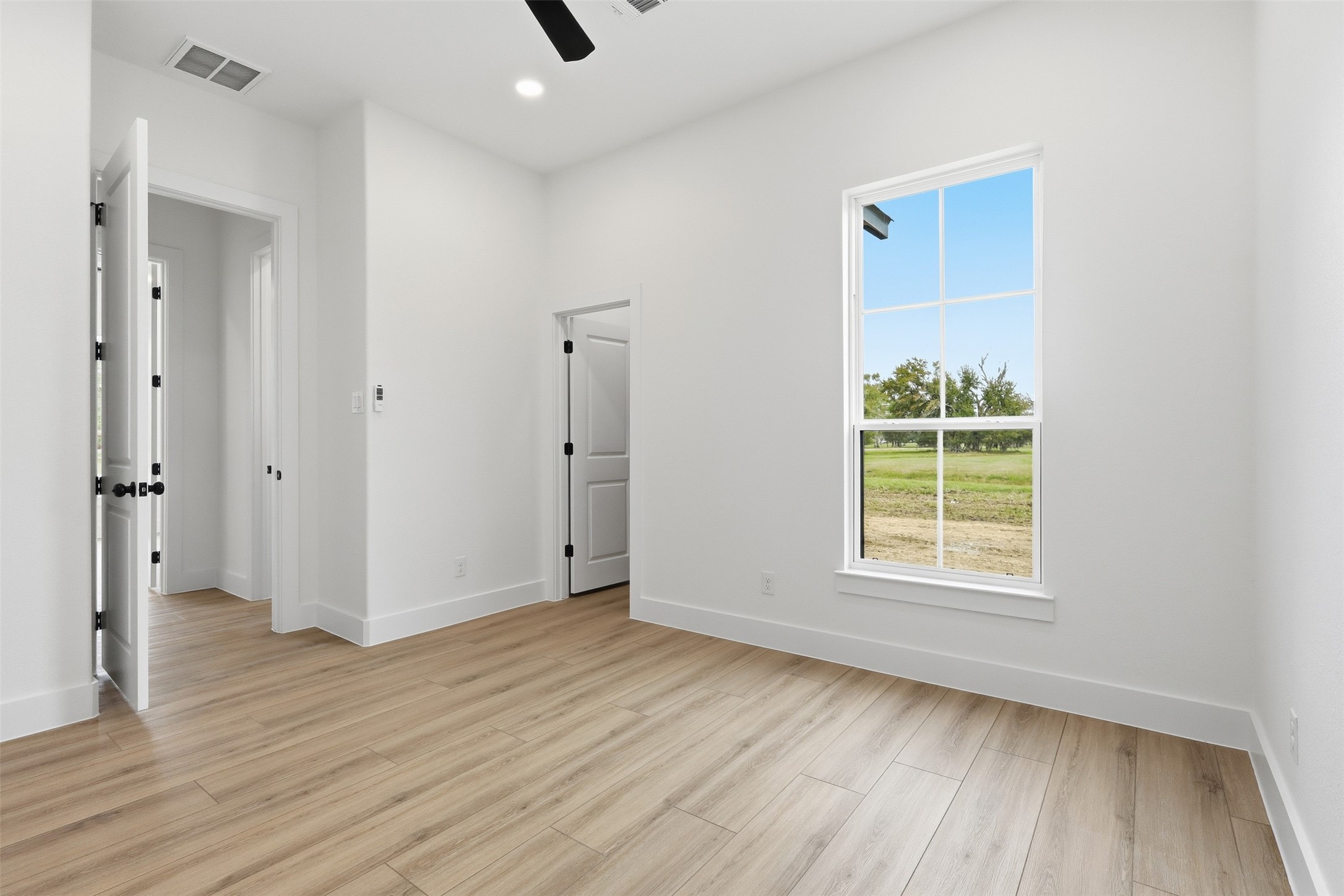 467 Springfield Drive Angleton, TX 77515 - Photo 27 of 42 an empty room with wooden floor and a window