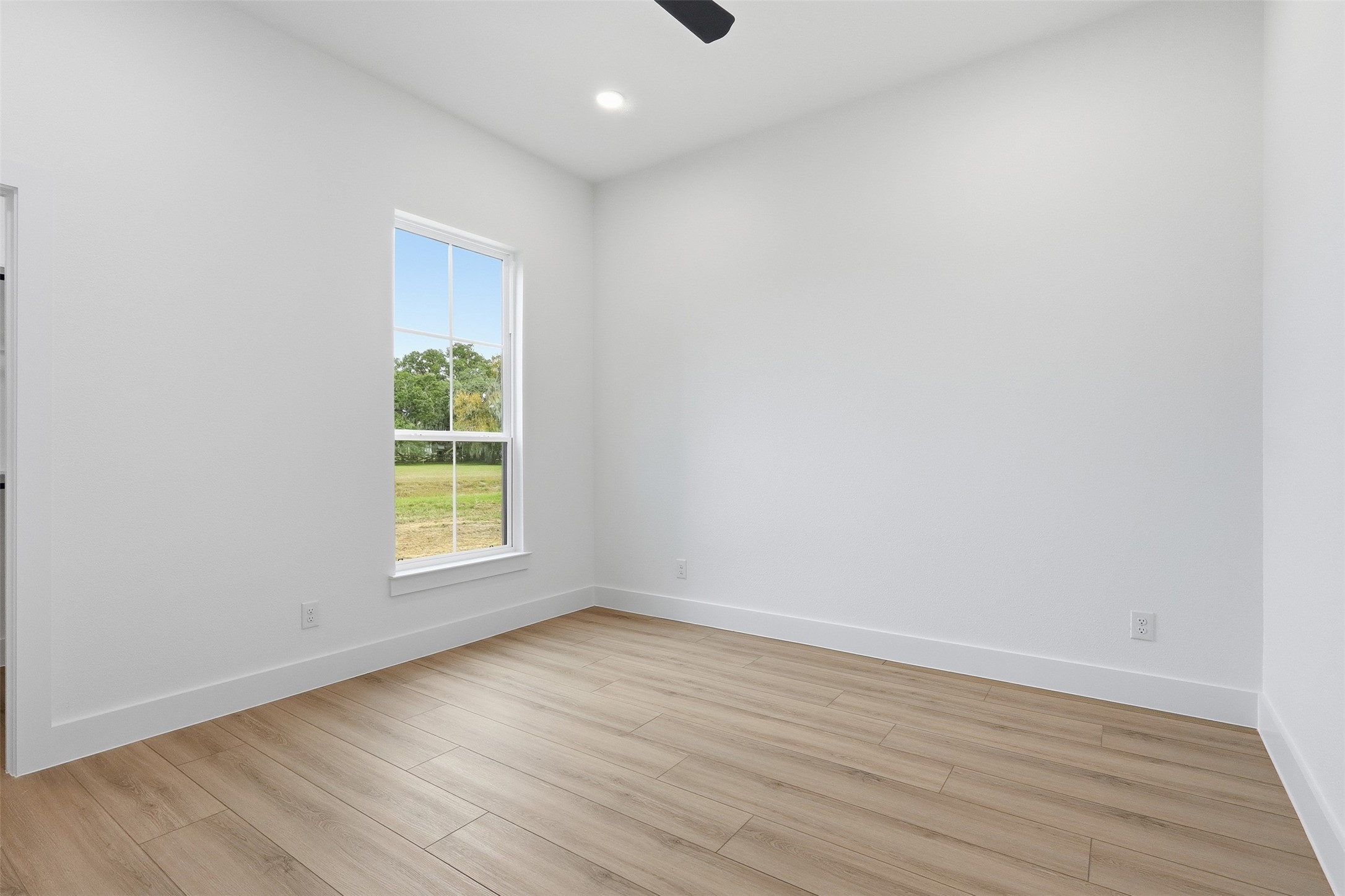 467 Springfield Drive Angleton, TX 77515 - Photo 28 of 42 an empty room with wooden floor and a window