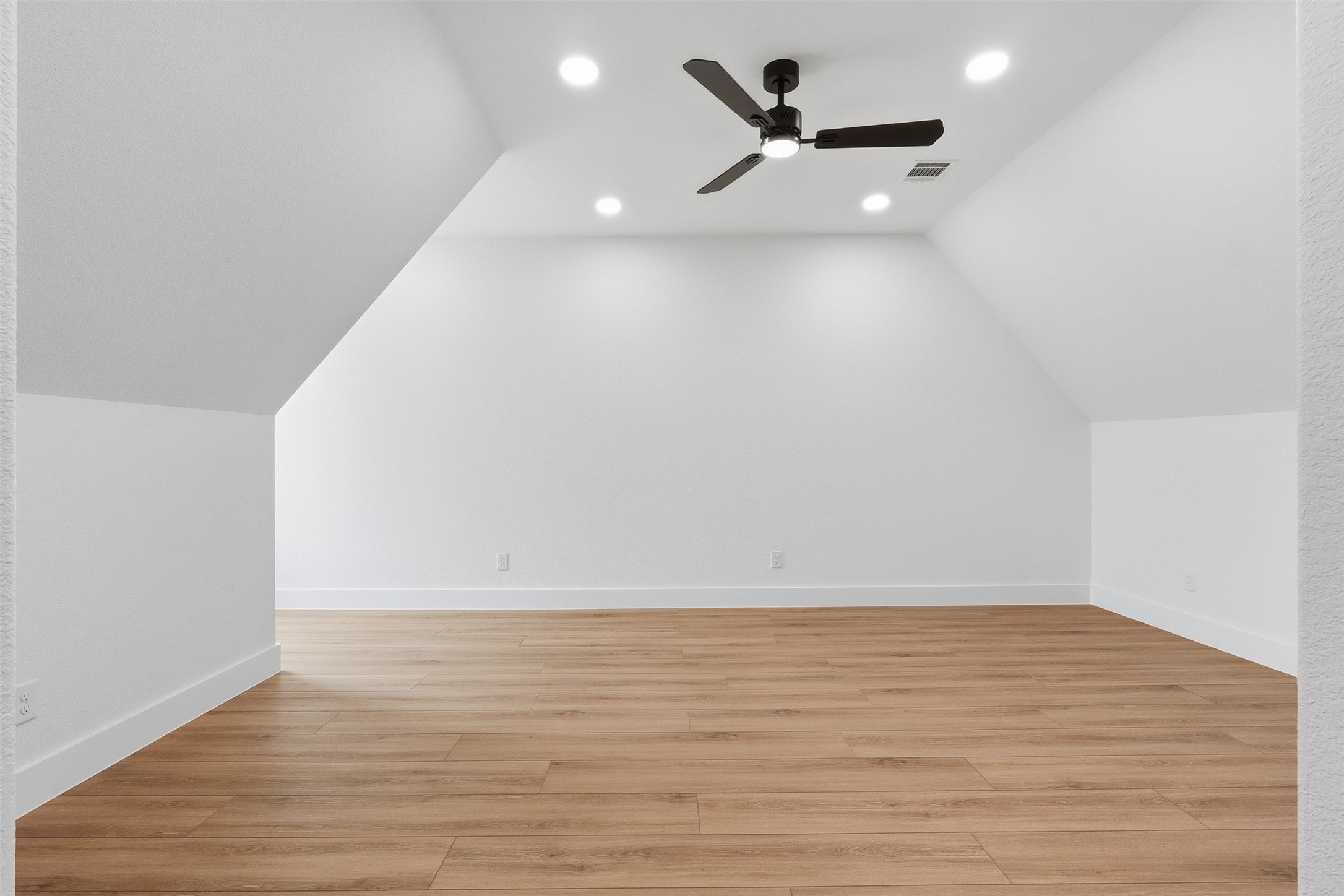 467 Springfield Drive Angleton, TX 77515 - Photo 30 of 42 a view of a room with wooden floor and a ceiling fan