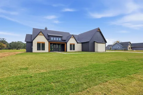 a front view of house with yard and green space