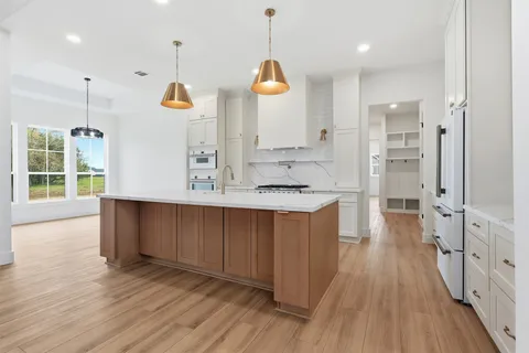 a view of kitchen with wooden floor and window