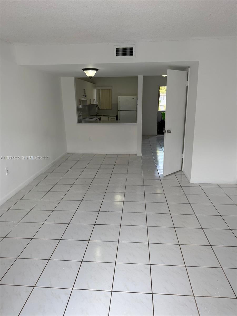 2680 West 76th Street, Unit 204 Hialeah, FL 33016 - Photo 3 of 14 a view of a livingroom with an empty space and a window
