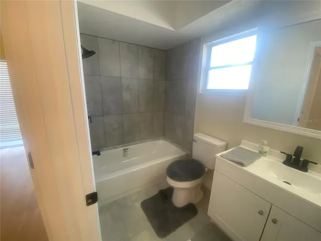 a bathroom with a tub a sink and a toilet