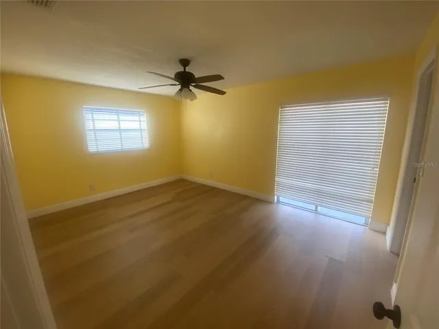 an empty room with windows and closet