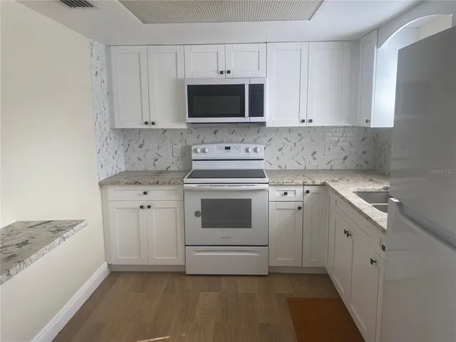 aerial view of a house with a backyard