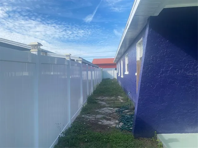 a view of a pathway of a house with a yard